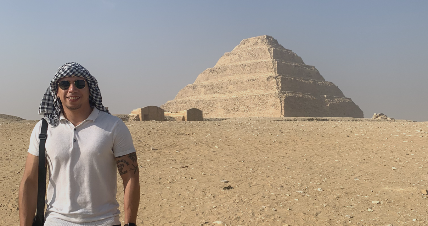 Miguel Tuiran standing in Egypt by a pyramid.